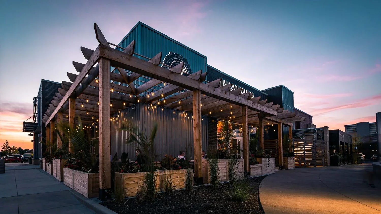 Restaurant patio and pergola glowing at dusk