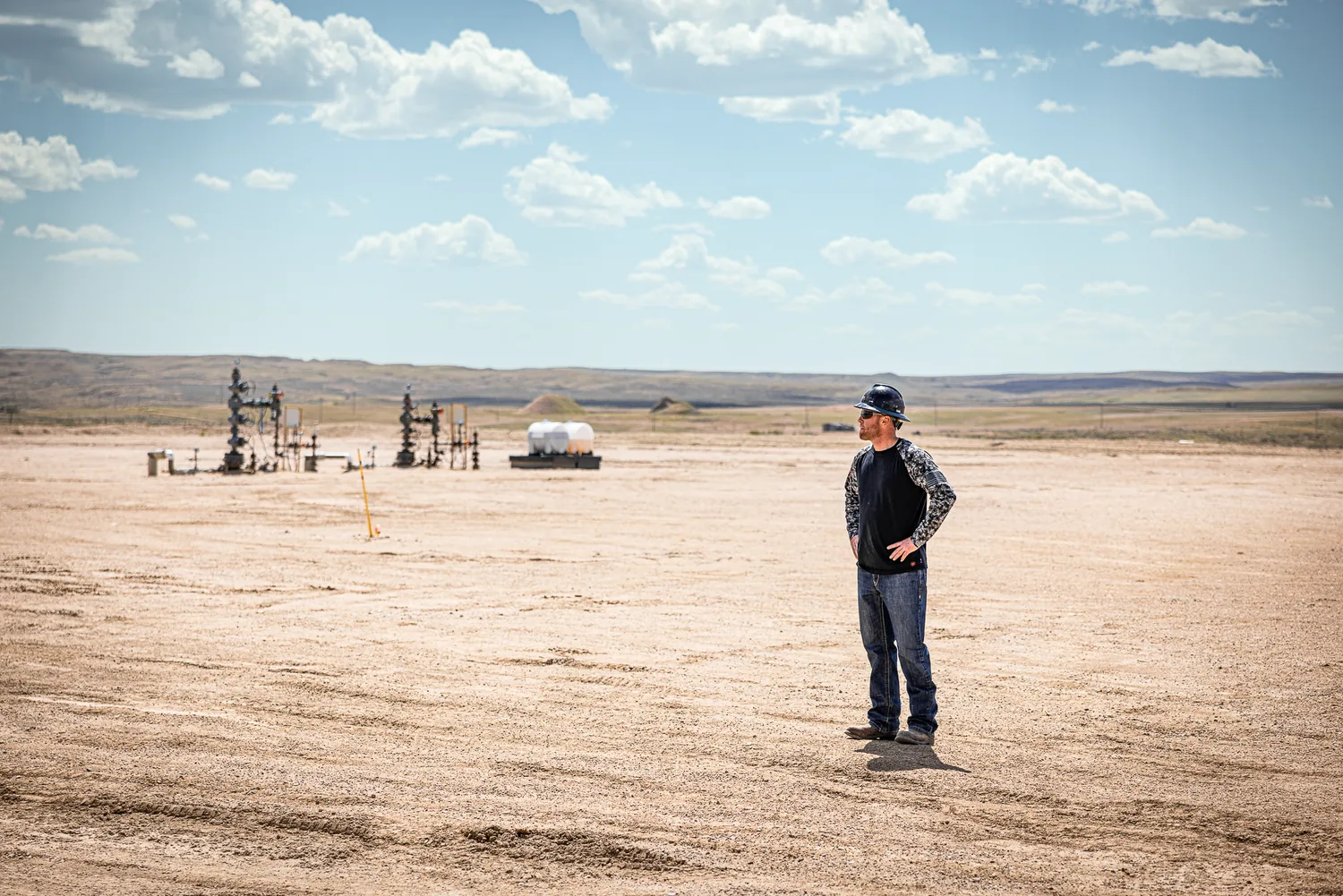 Field operator surveying a high-plains well site