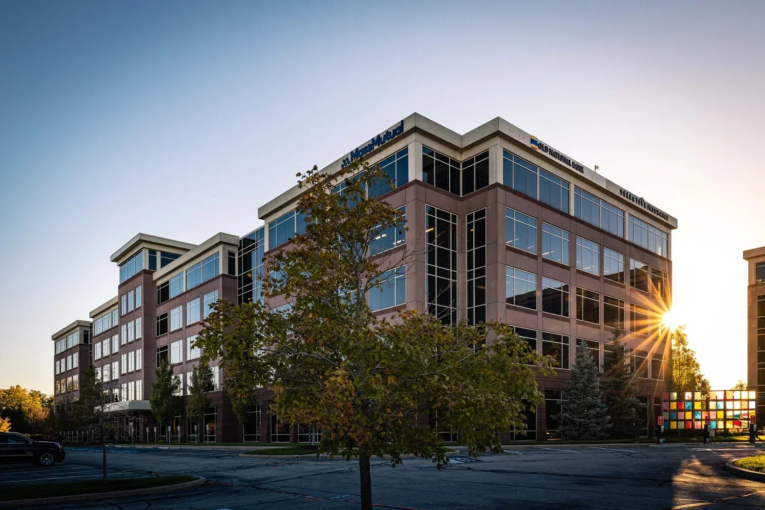 Parkwood office building with sunburst at sunset