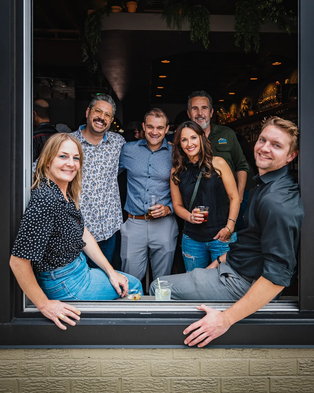 Team portrait framed in a restaurant window